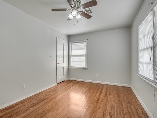 unfurnished room with ceiling fan, plenty of natural light, and light hardwood / wood-style floors