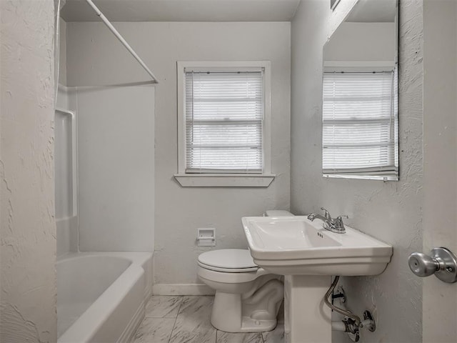 bathroom with  shower combination, toilet, and a healthy amount of sunlight