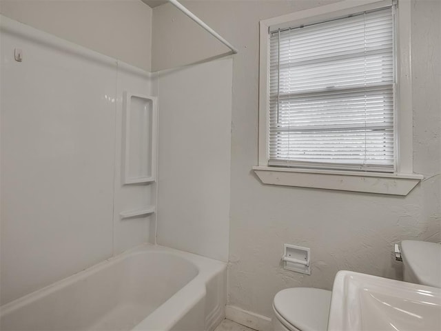 bathroom featuring bathtub / shower combination and toilet