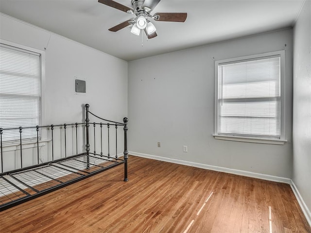 unfurnished bedroom featuring wood-type flooring and ceiling fan