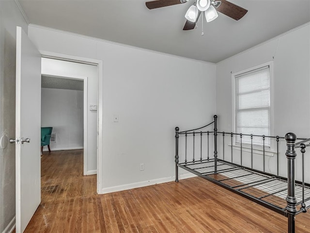 unfurnished bedroom featuring ornamental molding and hardwood / wood-style floors