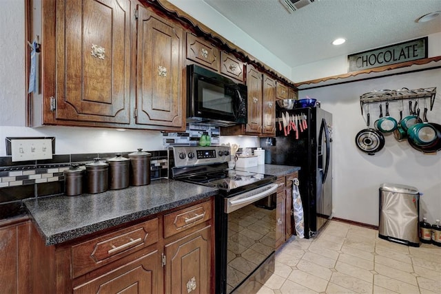 kitchen featuring backsplash, a textured ceiling, and black appliances