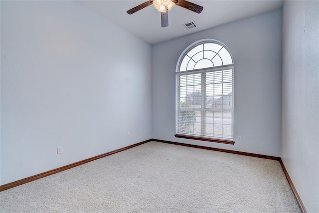 carpeted spare room with ceiling fan