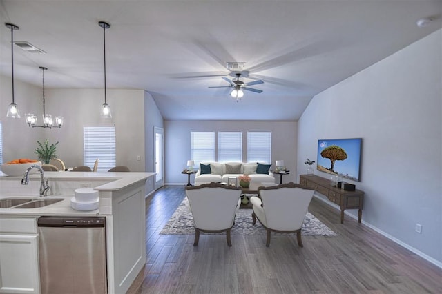 living room featuring ceiling fan with notable chandelier, sink, hardwood / wood-style floors, and lofted ceiling