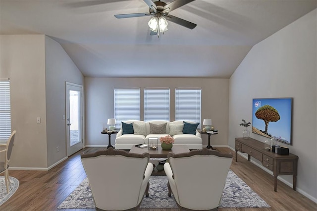 living room featuring lofted ceiling, wood-type flooring, and ceiling fan