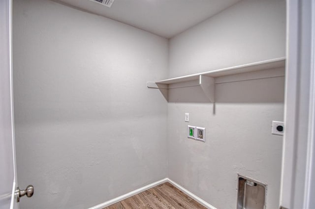 clothes washing area featuring electric dryer hookup, washer hookup, and hardwood / wood-style flooring