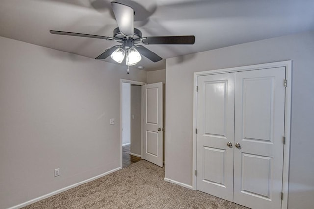 unfurnished bedroom featuring light colored carpet, a closet, and ceiling fan