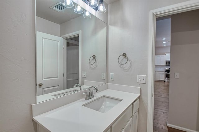 bathroom with vanity and hardwood / wood-style floors