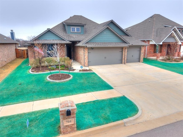 craftsman inspired home with a garage and a front yard