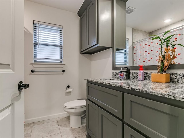 bathroom featuring tile patterned floors, vanity, toilet, and curtained shower