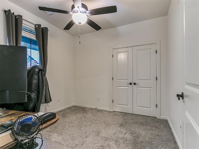 carpeted office with ceiling fan