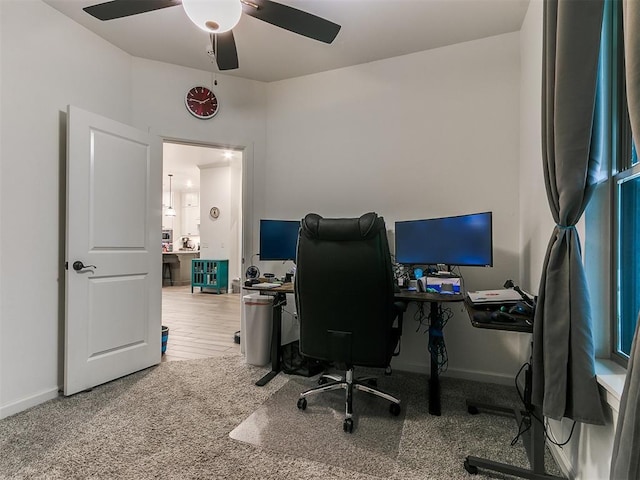 home office with ceiling fan and carpet flooring