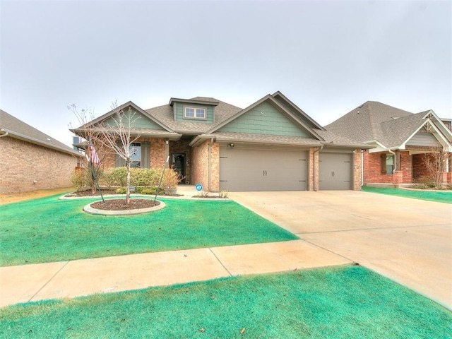 craftsman inspired home with a garage and a front lawn