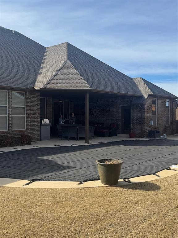 exterior space with a covered pool