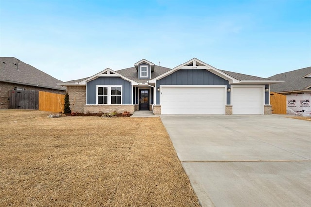 view of front of home with a garage and a front lawn