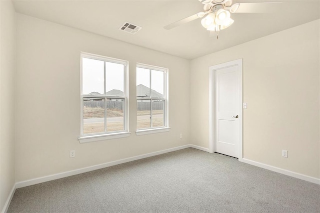 empty room featuring ceiling fan and carpet floors