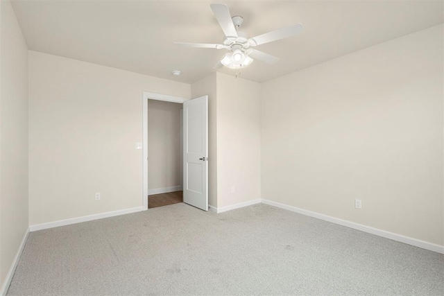 empty room featuring light carpet and ceiling fan