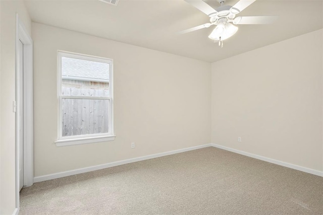 carpeted empty room featuring ceiling fan