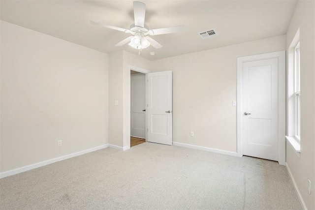 unfurnished bedroom featuring ceiling fan and light colored carpet