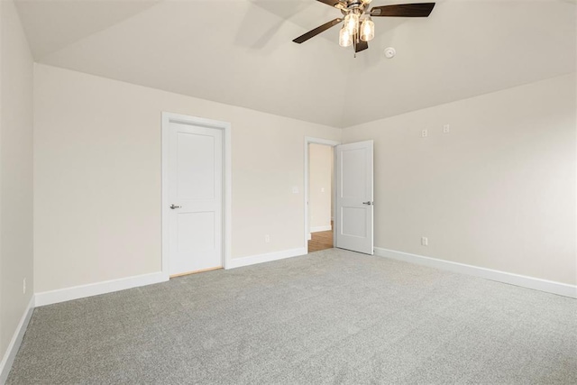 unfurnished bedroom with ceiling fan, lofted ceiling, and carpet