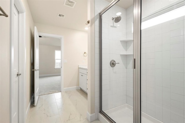 bathroom with vanity and a shower with shower door