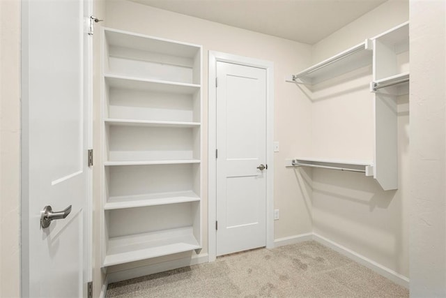 spacious closet with light colored carpet