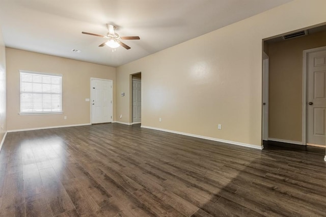 unfurnished room featuring dark wood-type flooring and ceiling fan