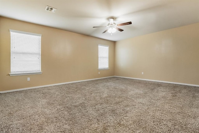 carpeted empty room featuring ceiling fan