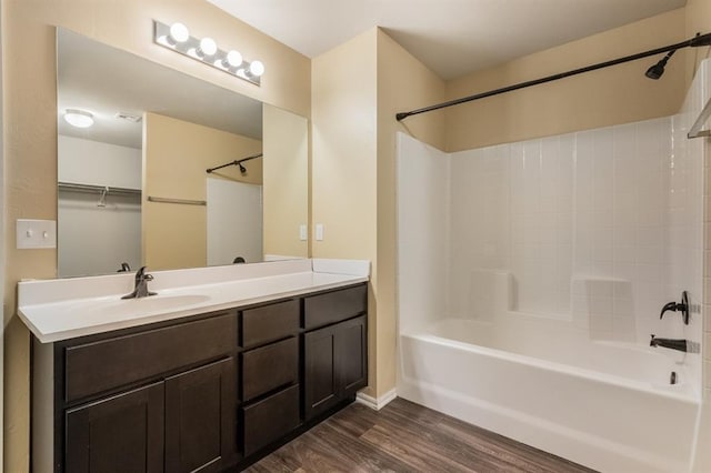 bathroom featuring vanity, hardwood / wood-style flooring, and shower / bathtub combination