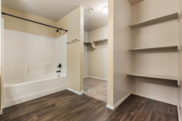 bathroom with hardwood / wood-style floors and shower / washtub combination