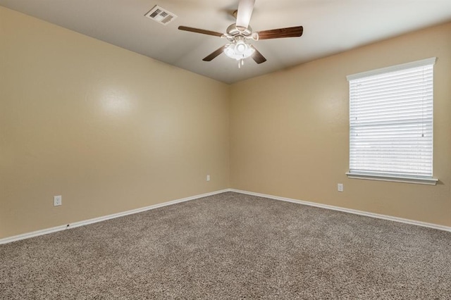 carpeted spare room with ceiling fan