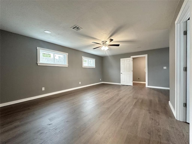 unfurnished bedroom with ceiling fan, dark hardwood / wood-style floors, and a textured ceiling