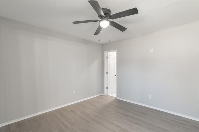 empty room featuring ceiling fan and light hardwood / wood-style flooring