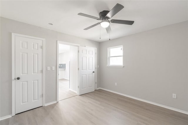 unfurnished bedroom with ceiling fan and light hardwood / wood-style flooring