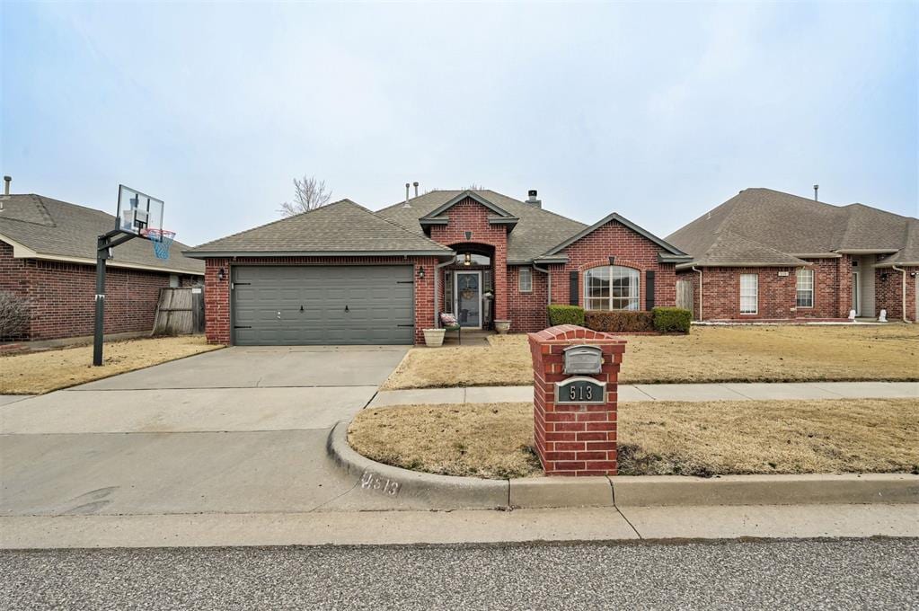 single story home featuring a garage and a front yard