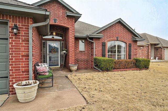 doorway to property with a yard