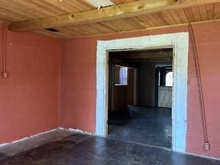 spare room with beam ceiling and wooden ceiling