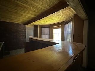 additional living space featuring wooden ceiling and beamed ceiling