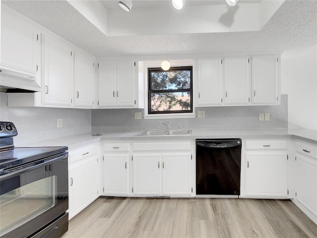 kitchen featuring sink, black appliances, a textured ceiling, white cabinets, and light wood-type flooring