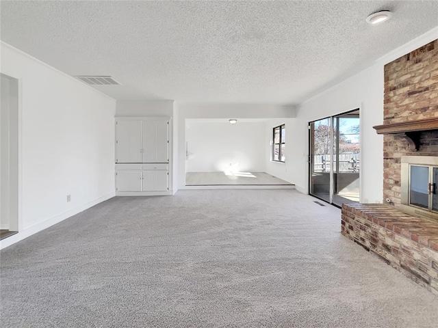 unfurnished living room with a fireplace, light carpet, and a textured ceiling