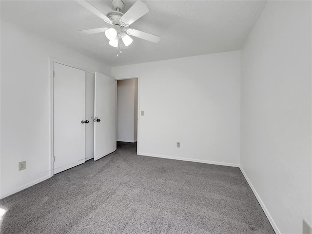 unfurnished bedroom with a textured ceiling, ceiling fan, and carpet flooring