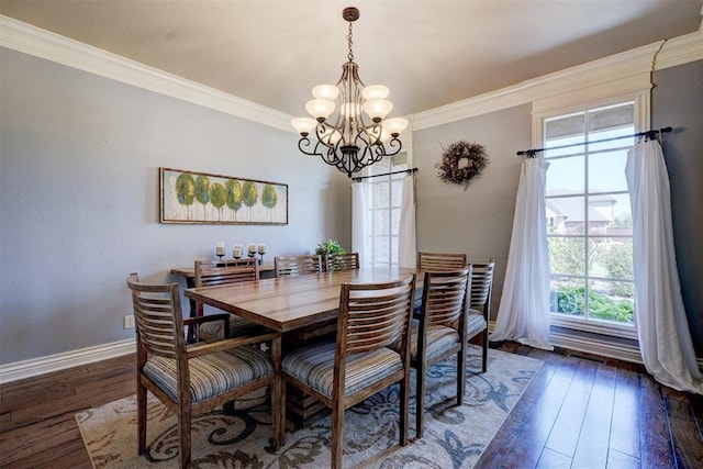 dining area featuring dark wood-type flooring, ornamental molding, and a notable chandelier