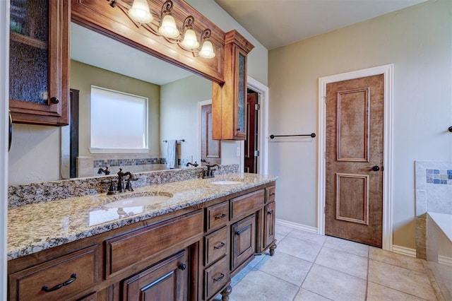 bathroom featuring vanity, a bath, and tile patterned floors