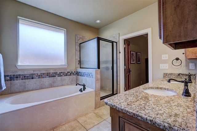 bathroom featuring vanity, shower with separate bathtub, and tile patterned flooring