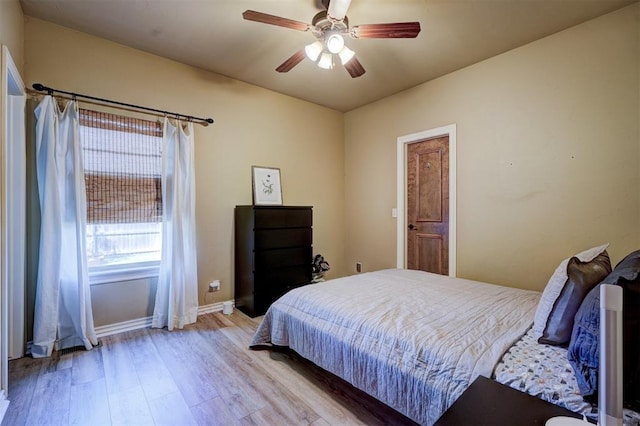 bedroom with ceiling fan and light hardwood / wood-style floors