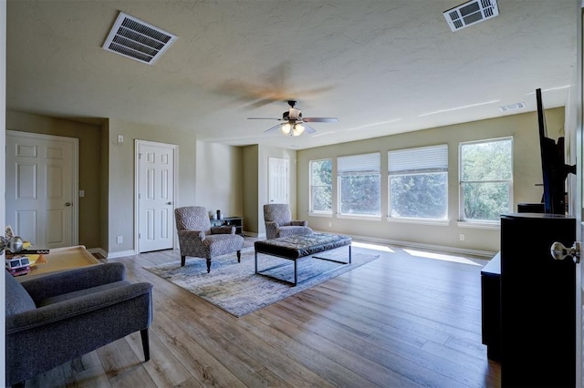 living room with light hardwood / wood-style floors and ceiling fan