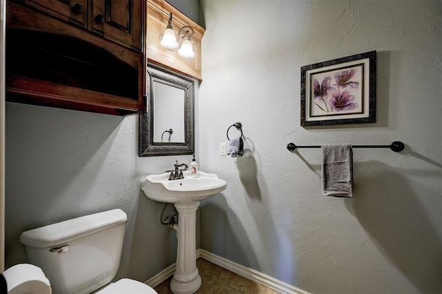 bathroom with tile patterned flooring and toilet