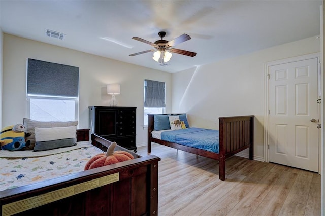 bedroom with ceiling fan and light wood-type flooring