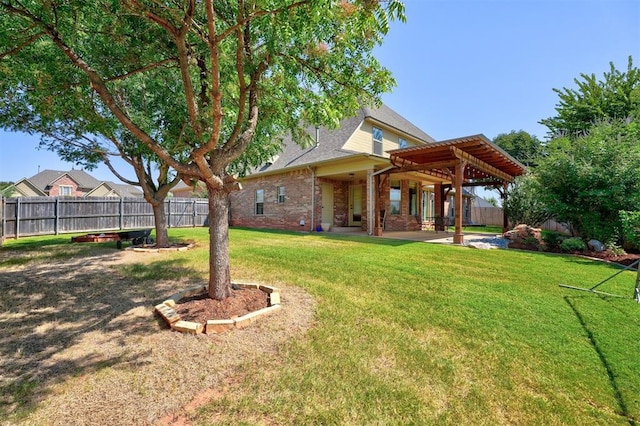 rear view of property with a patio, a yard, and a pergola