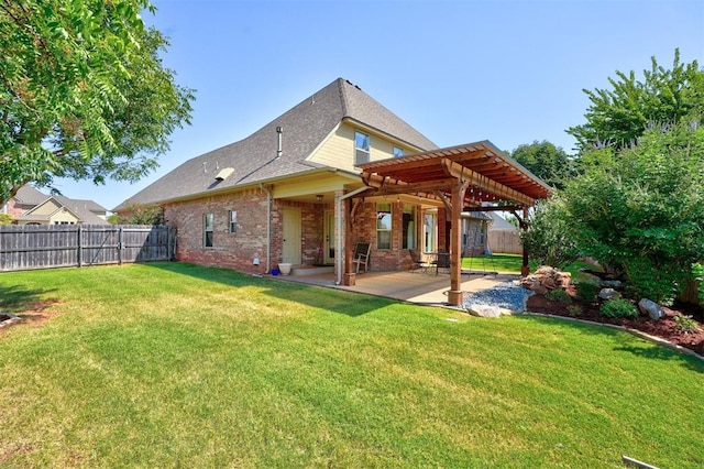 rear view of property with a pergola, a patio area, and a lawn